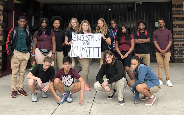  JHT Staff stands outside the administration building holding a copy of Greta's protest sign.